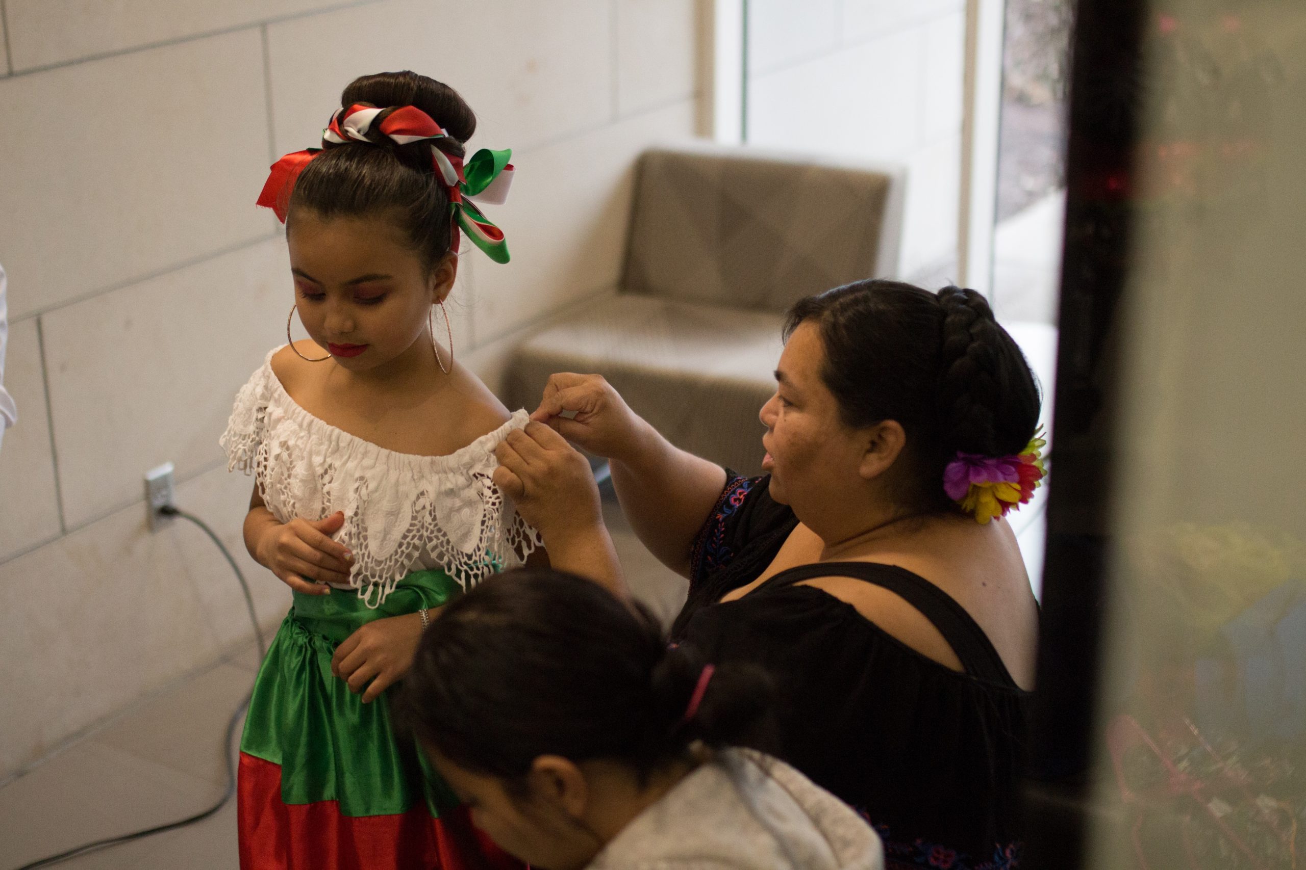 Maria repairing a dress for one of the dancers.