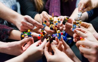 People holding lego people