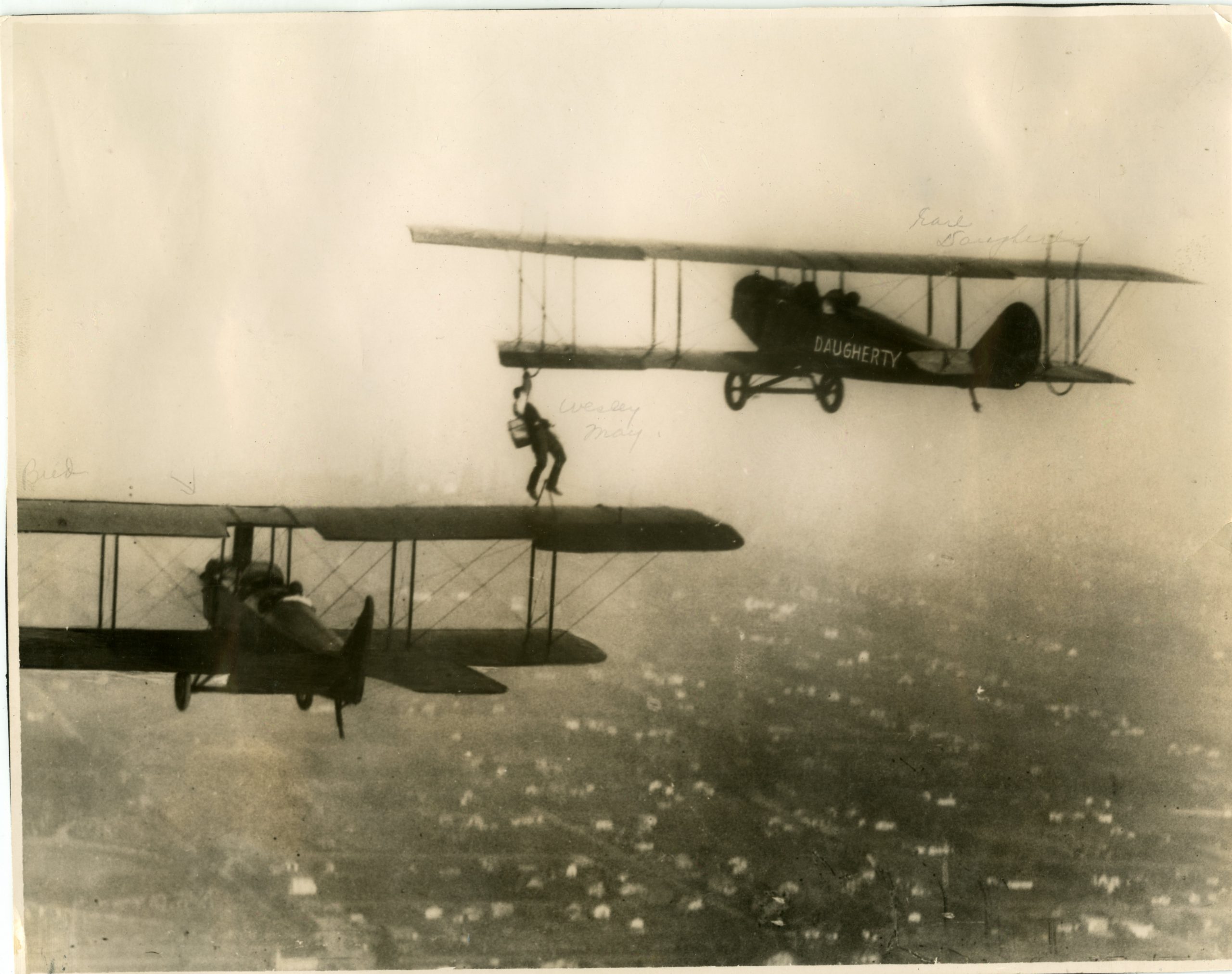Bud Creeth and Earl May flying with Wesley May walking on the wing.