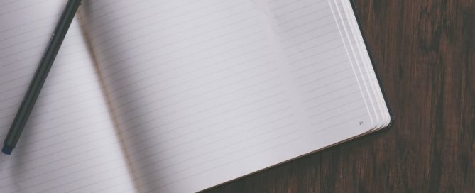 Journal open to empty page with pen