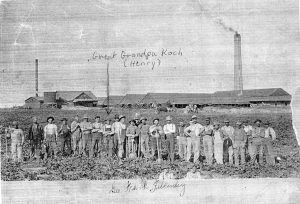 Employees of Western Brick and Supply, brick factory in the distance