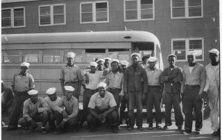 Black Navy enlisted men in front of a cattle car
