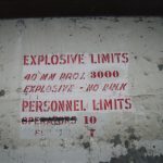 Sign inside cubical of the 40mm production building. Reads: Explosive Limits, 40mm projectile 3000,Explosive - no bulk, Personnel limits, operators 10