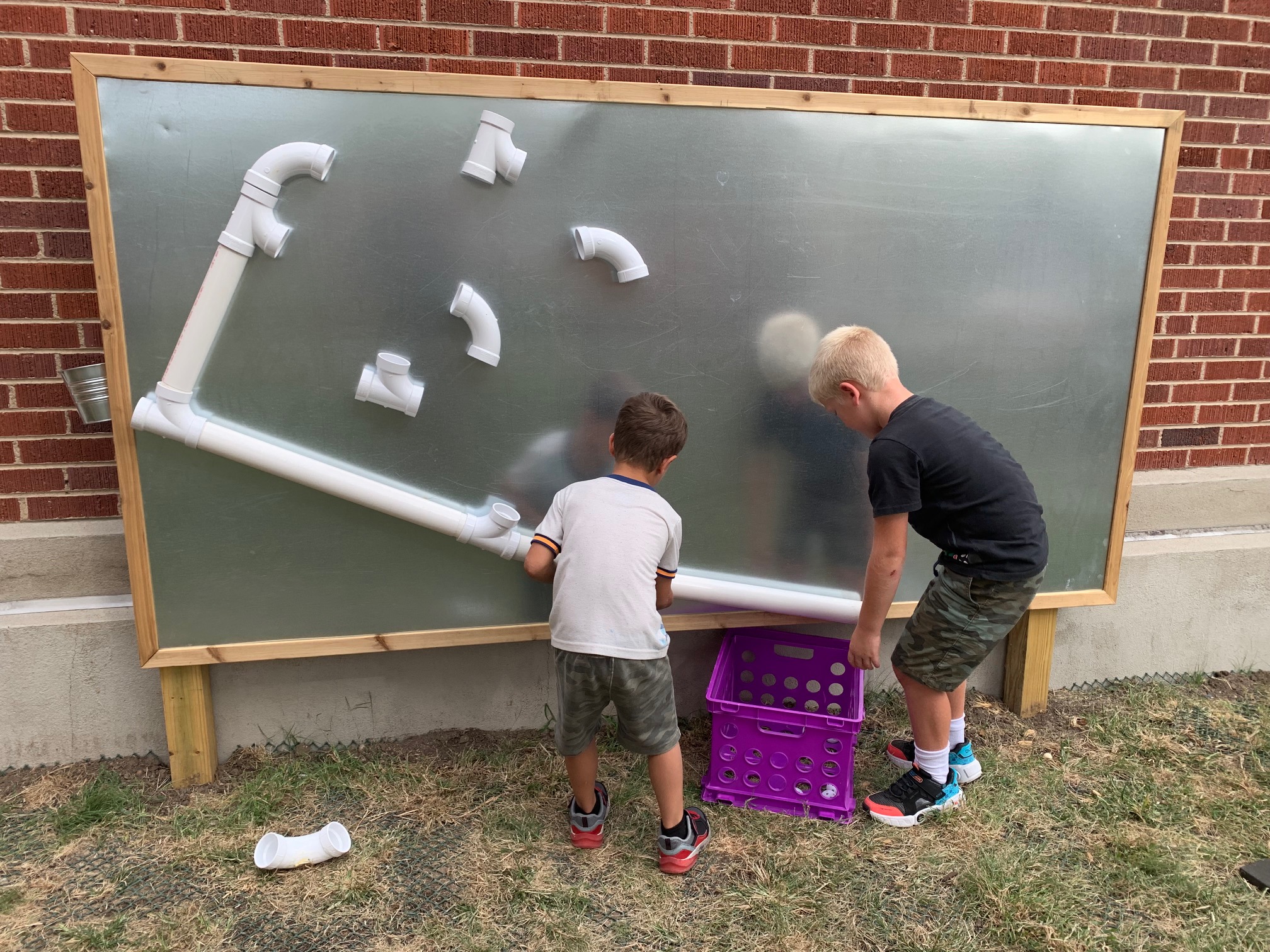 Boys playing with a magnetic wall