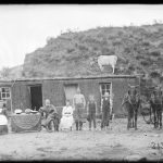 Family in front of their soddy with watermelon. Photo taken by Solomon Butcher